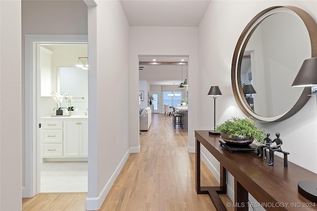 hallway featuring light hardwood / wood-style floors and sink