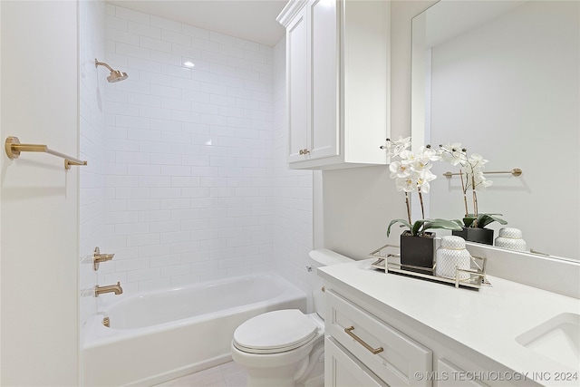 full bathroom featuring vanity, tile patterned flooring, tiled shower / bath, and toilet