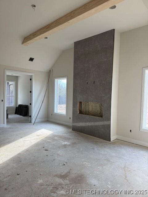 unfurnished living room with a healthy amount of sunlight and baseboards