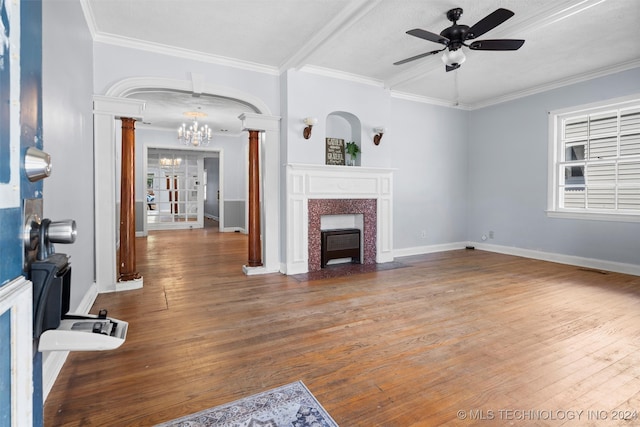 living room with ornate columns, ceiling fan with notable chandelier, a textured ceiling, hardwood / wood-style flooring, and ornamental molding