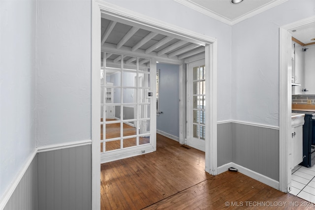 interior space with hardwood / wood-style flooring and crown molding