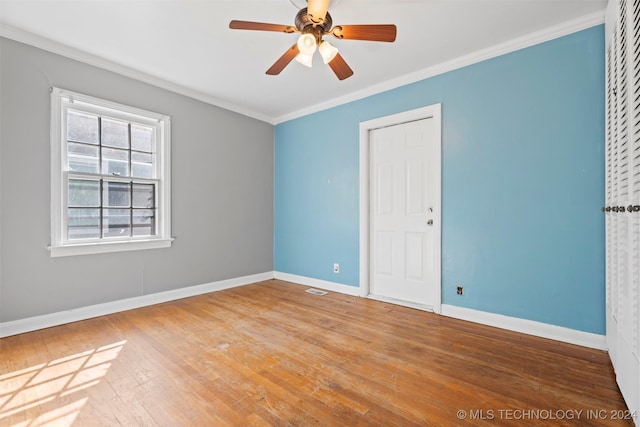 spare room with hardwood / wood-style flooring, ceiling fan, and ornamental molding