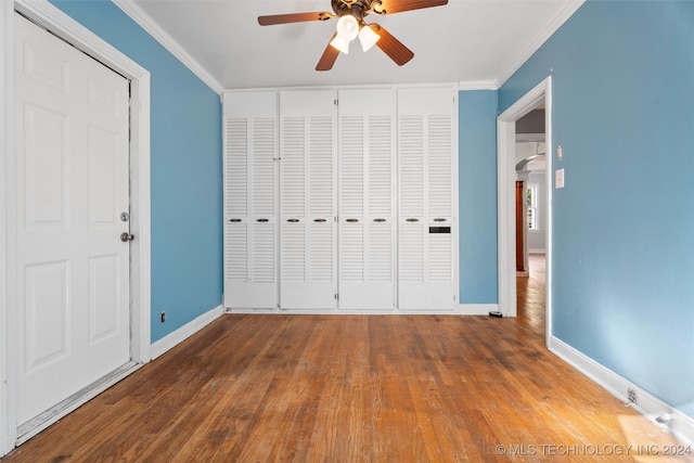 unfurnished bedroom with ornamental molding, dark hardwood / wood-style flooring, and ceiling fan