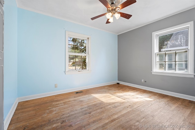 spare room with hardwood / wood-style flooring, ceiling fan, and crown molding