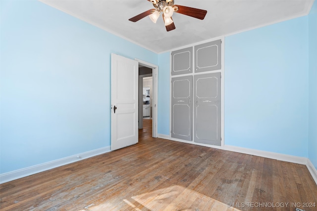 unfurnished bedroom with light hardwood / wood-style floors, ceiling fan, and a closet