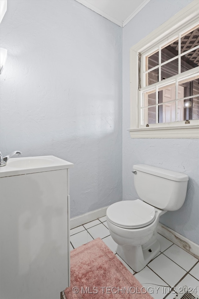 bathroom featuring toilet, ornamental molding, and tile patterned floors