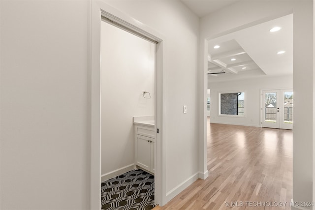 corridor with french doors, recessed lighting, light wood-type flooring, coffered ceiling, and baseboards