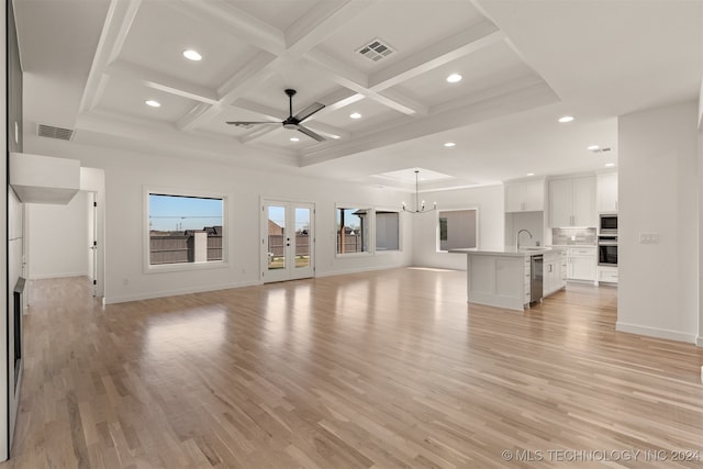 unfurnished living room with light hardwood / wood-style floors, ceiling fan with notable chandelier, coffered ceiling, beam ceiling, and sink