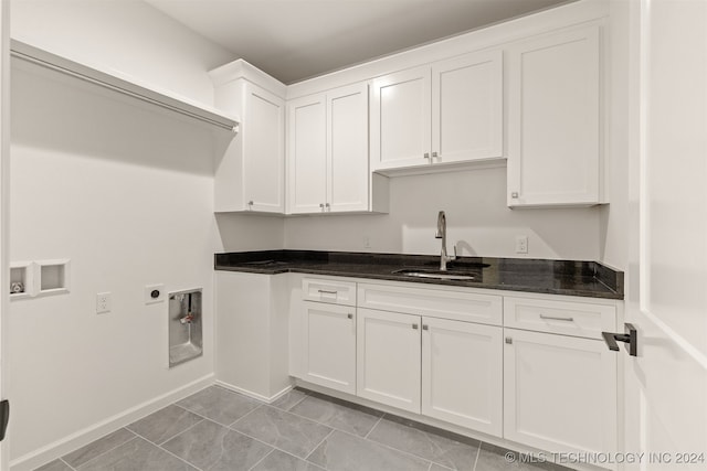 laundry area featuring light tile patterned floors, hookup for a washing machine, hookup for an electric dryer, a sink, and cabinet space