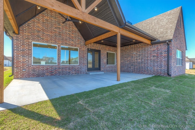 back of property featuring a yard and a patio area