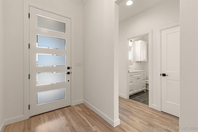 entrance foyer with baseboards, recessed lighting, and light wood-style floors