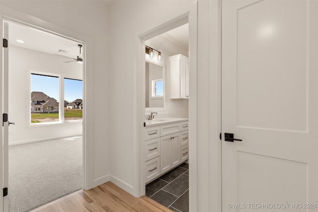 bathroom featuring hardwood / wood-style floors, vanity, and ceiling fan