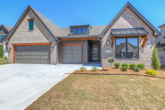 view of front of home featuring a garage, a front lawn, concrete driveway, and brick siding