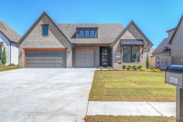 view of front facade featuring an attached garage, brick siding, a shingled roof, driveway, and a front lawn