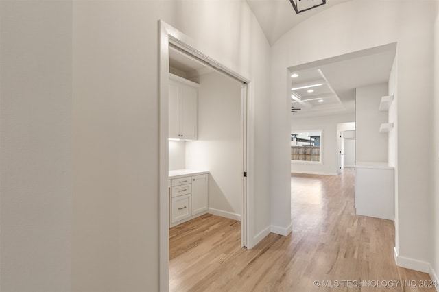 hall featuring baseboards, coffered ceiling, light wood-style floors, beam ceiling, and recessed lighting