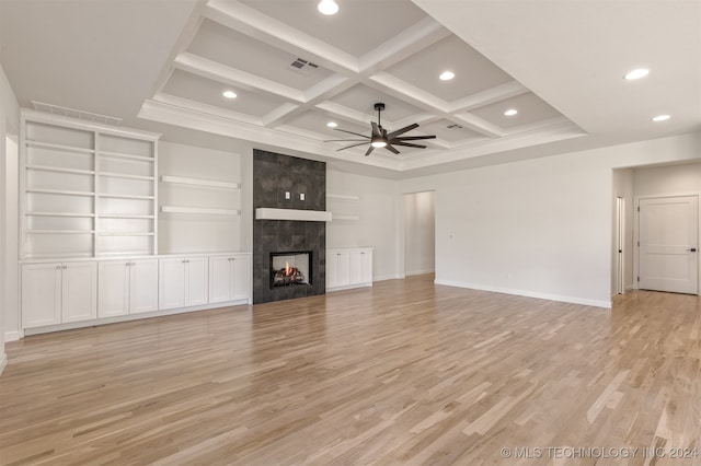 unfurnished living room with ceiling fan, a high end fireplace, coffered ceiling, and light hardwood / wood-style flooring