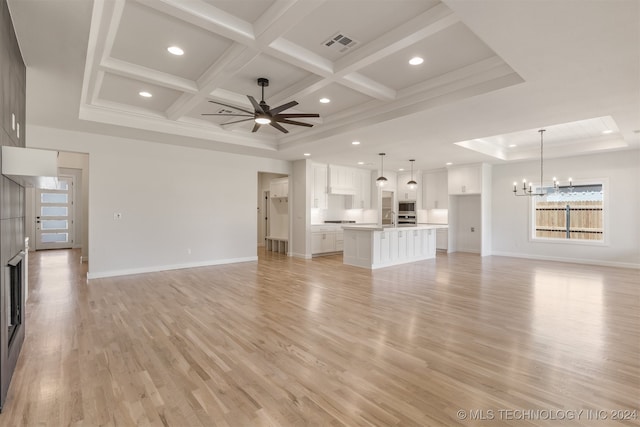 unfurnished living room with sink, beam ceiling, coffered ceiling, ceiling fan with notable chandelier, and light hardwood / wood-style floors