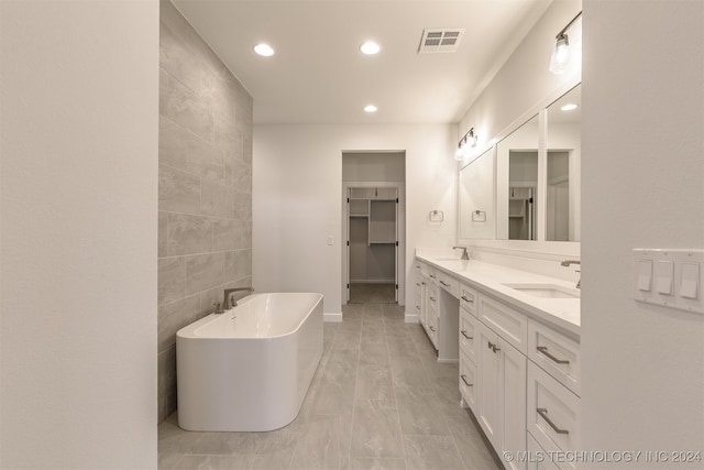 bathroom featuring vanity, a bathing tub, and tile walls