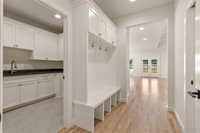 mudroom with baseboards, french doors, a sink, and recessed lighting