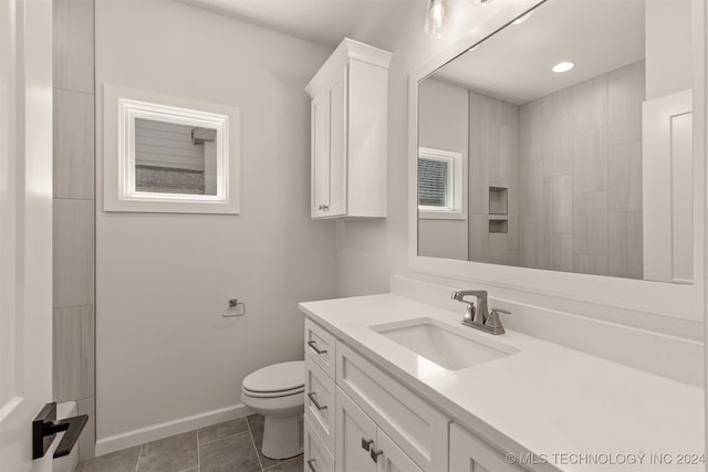 bathroom featuring tile patterned flooring, vanity, and toilet