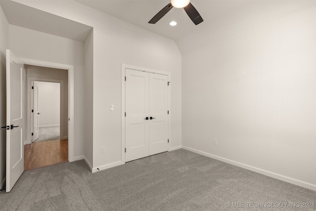 unfurnished bedroom featuring carpet floors, recessed lighting, a closet, vaulted ceiling, and baseboards