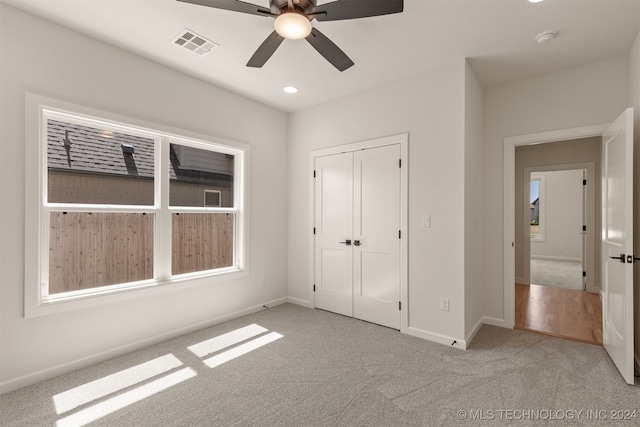 unfurnished bedroom with light carpet, baseboards, visible vents, a closet, and recessed lighting