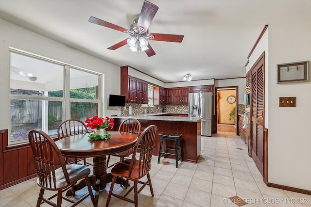 tiled dining room featuring ceiling fan