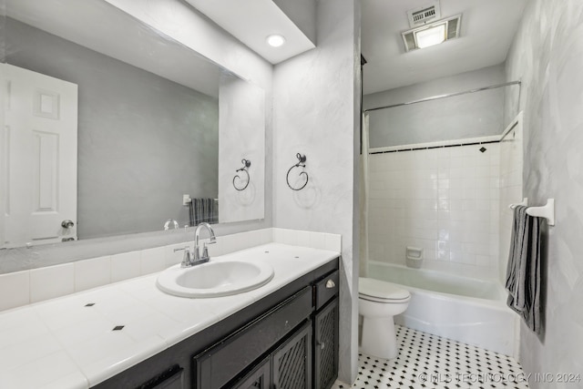 full bathroom featuring vanity, toilet, and tiled shower / bath