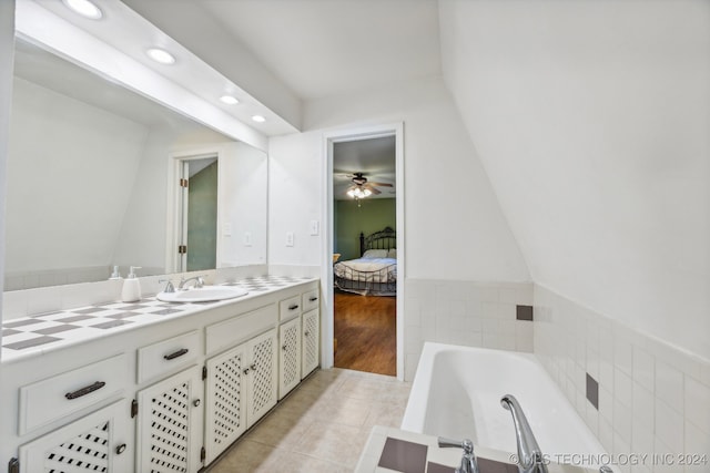 bathroom with vanity, a tub to relax in, tile patterned floors, and ceiling fan