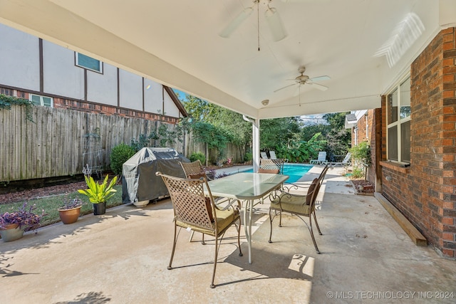 view of patio / terrace featuring area for grilling, ceiling fan, and a fenced in pool