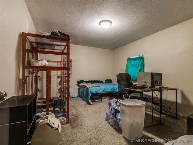 bedroom with carpet and a textured ceiling