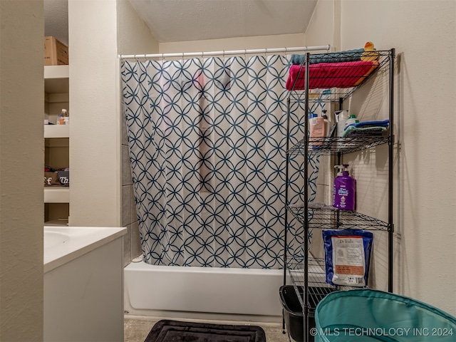 bathroom with vanity, a textured ceiling, and shower / tub combo with curtain