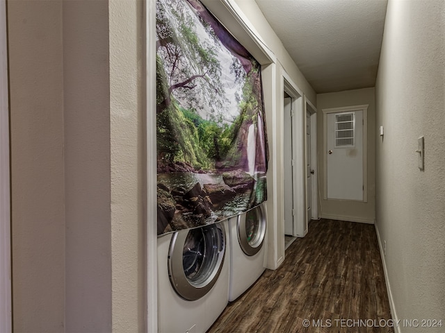 laundry area featuring washing machine and clothes dryer, dark wood-type flooring, and a textured ceiling