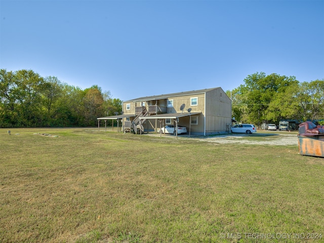 back of property featuring a lawn