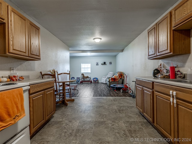 kitchen featuring white range oven and dark hardwood / wood-style flooring