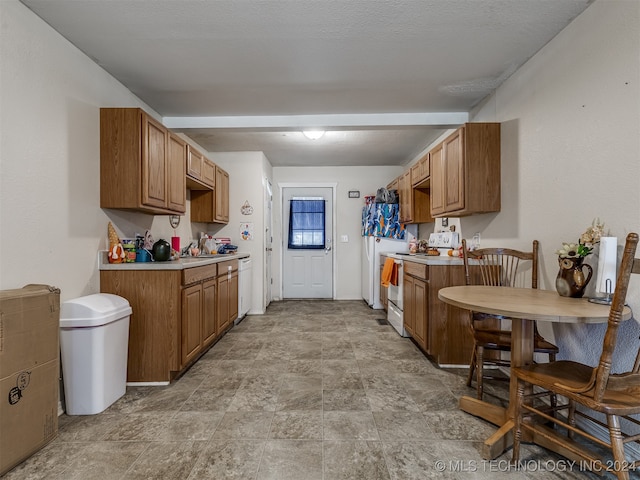 kitchen featuring white appliances and a textured ceiling