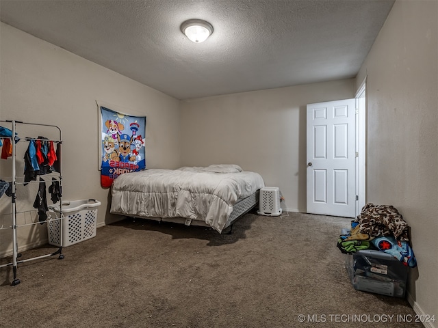 carpeted bedroom featuring a textured ceiling