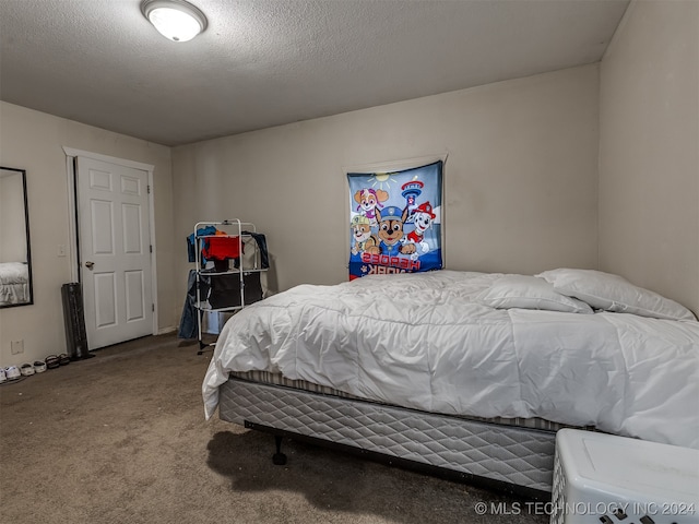 carpeted bedroom with a textured ceiling