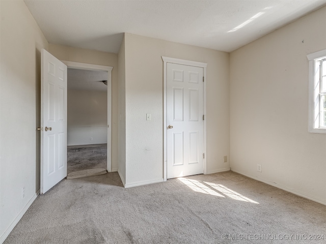 unfurnished bedroom featuring light colored carpet