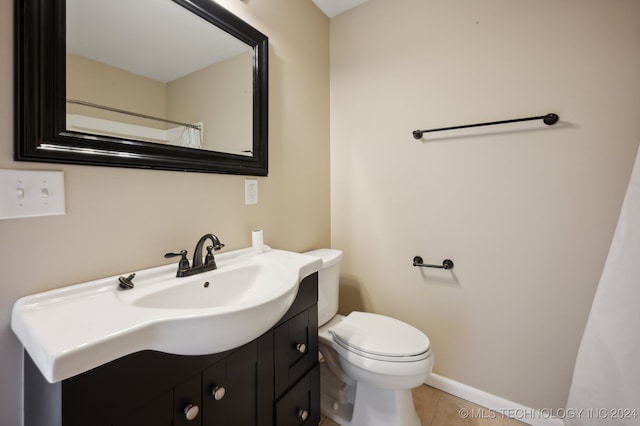 bathroom featuring tile patterned floors, toilet, walk in shower, and vanity