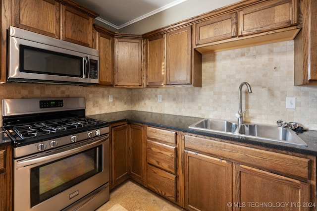 kitchen with backsplash, appliances with stainless steel finishes, crown molding, and sink