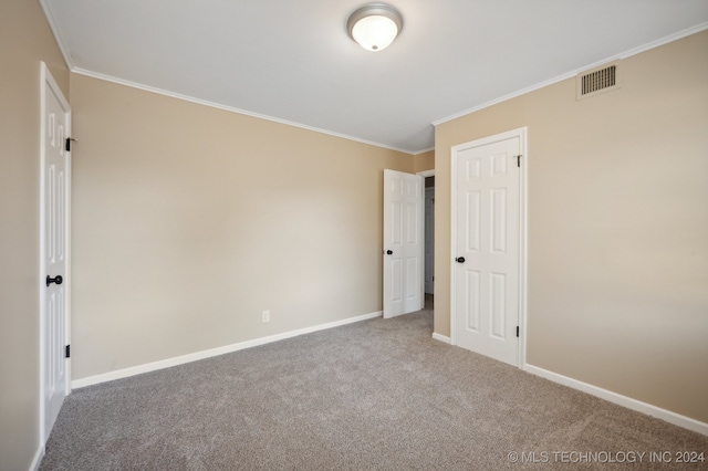 carpeted empty room featuring ornamental molding