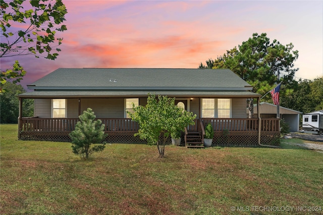 back house at dusk featuring a yard