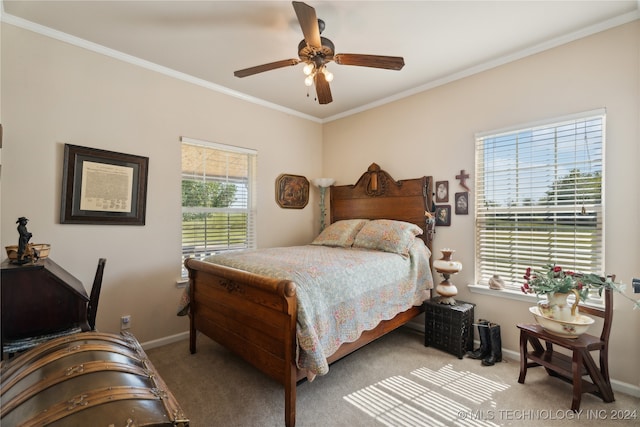 carpeted bedroom featuring ceiling fan and ornamental molding