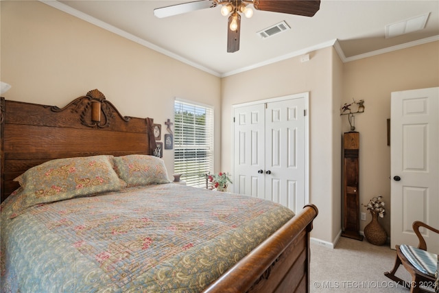 bedroom featuring ceiling fan, a closet, light colored carpet, and ornamental molding