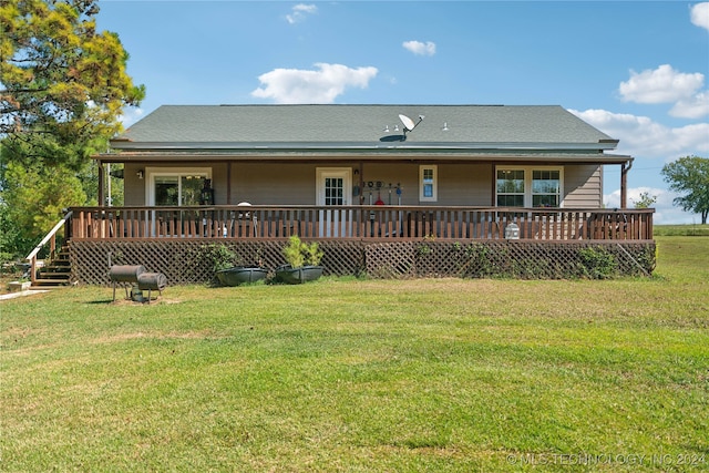 back of property featuring a lawn