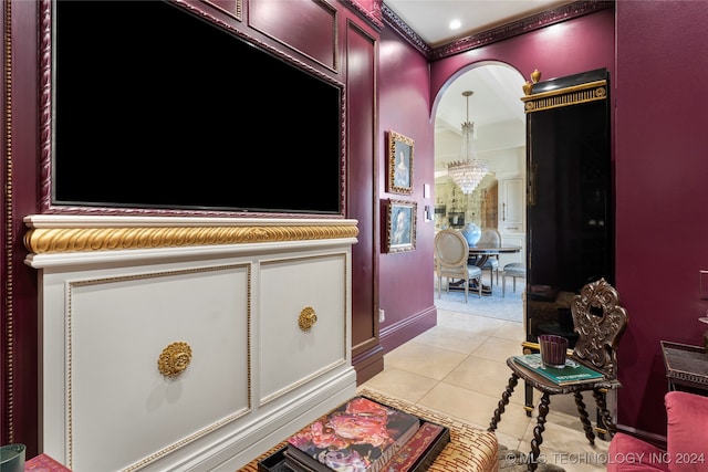 corridor featuring crown molding, light tile patterned flooring, and a chandelier