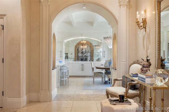 bathroom featuring beamed ceiling, tile patterned floors, and ornate columns