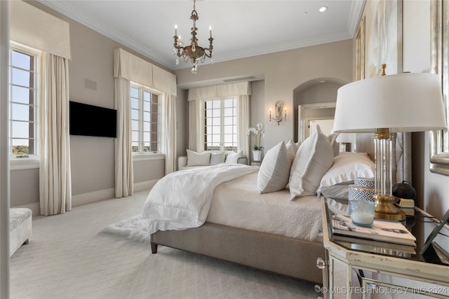 bedroom with light carpet, ornamental molding, and a chandelier