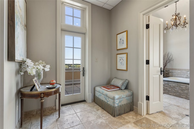 entryway with a chandelier and a paneled ceiling